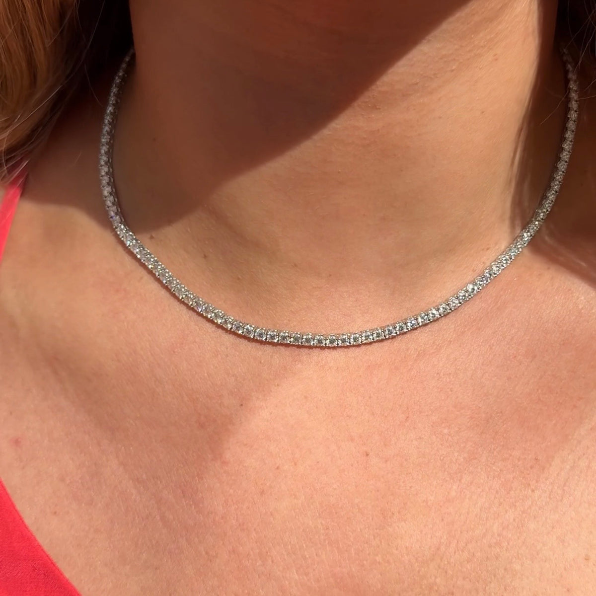 Moissanite tennis necklace worn close to the neck