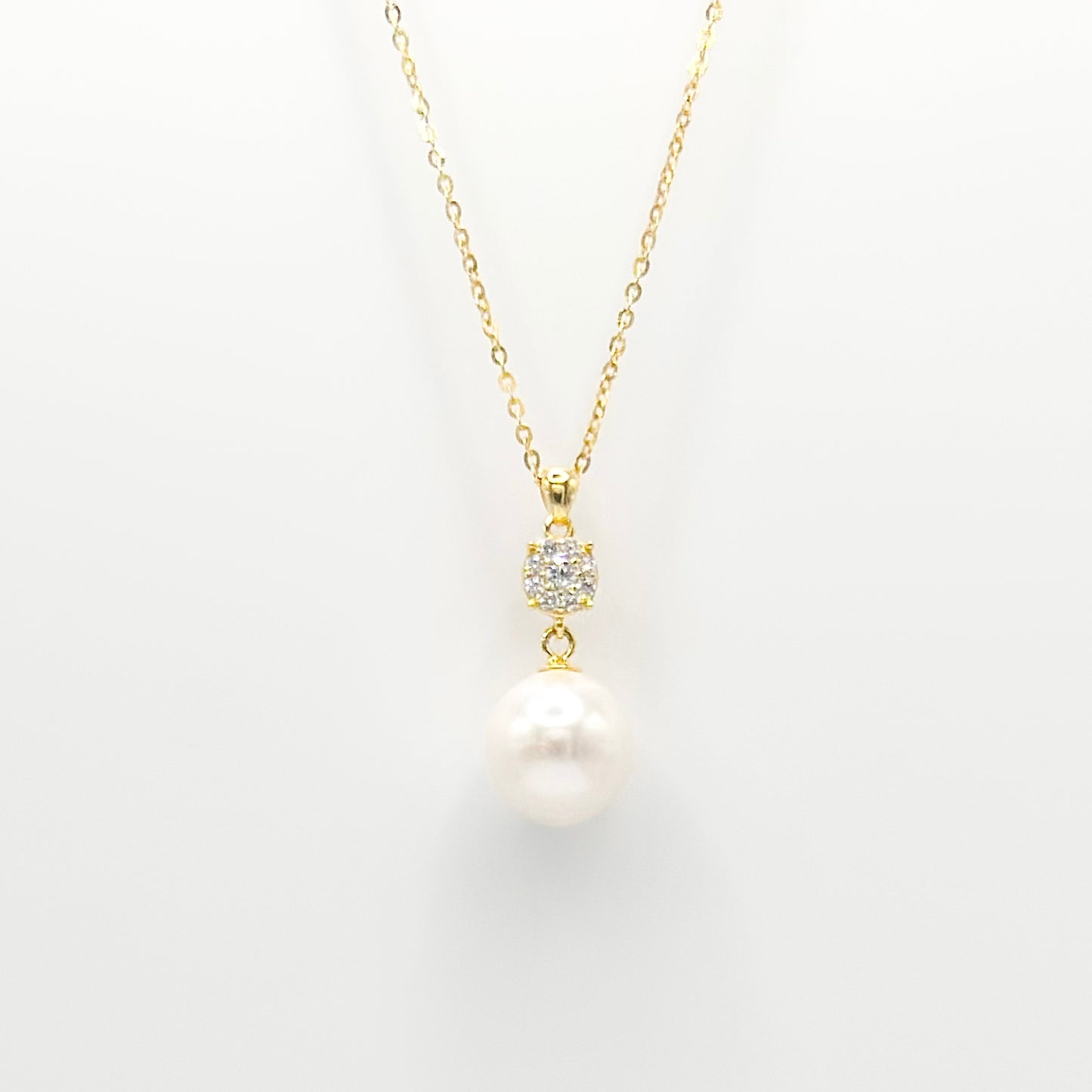 Gold pearl and diamante drop necklace with round pearl pendant and studded clasp