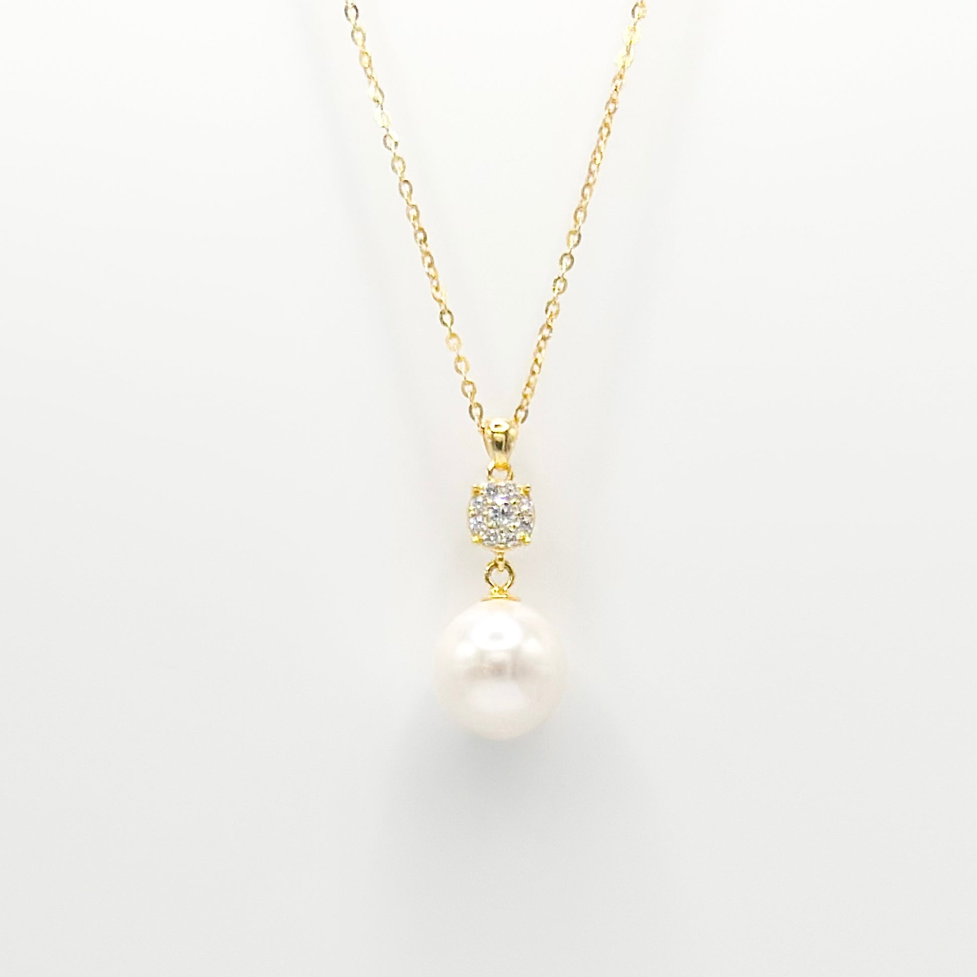Gold pearl and diamante drop necklace with round pearl pendant and studded clasp