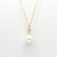 Gold pearl and diamante drop necklace with round pearl pendant and studded clasp