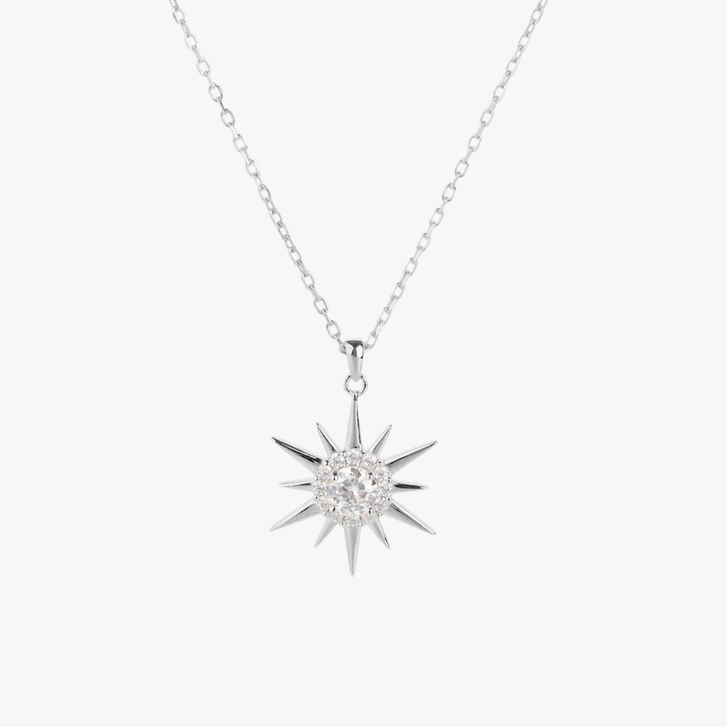 Silver starburst pendant necklace with round crystal center and spiked rays