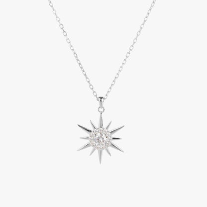 Silver starburst pendant necklace with round crystal center and spiked rays