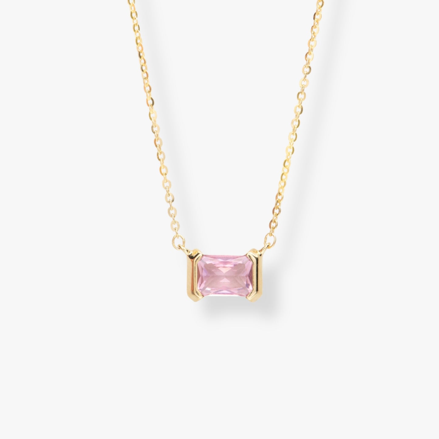 Gold-tone necklace with pink square gemstone pendant and link chain