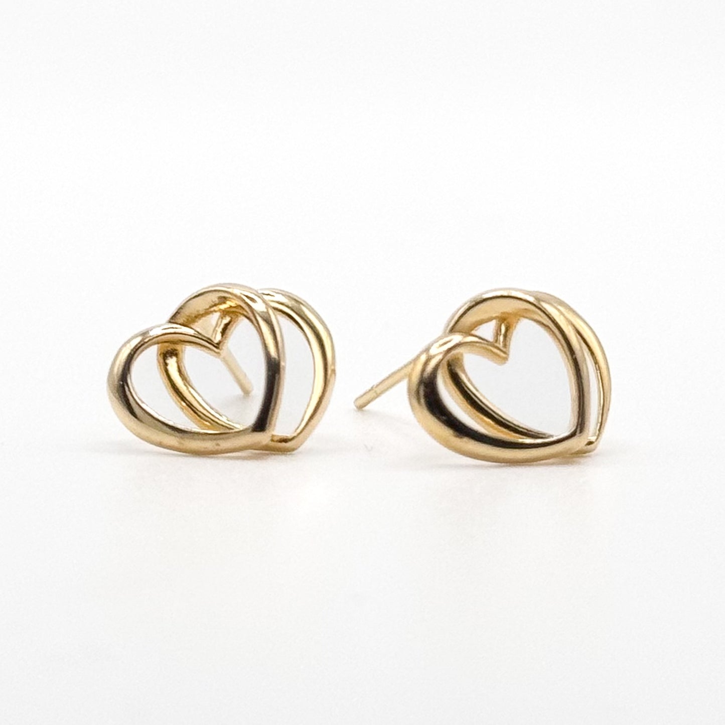 Gold-tone heart stud earrings with curved interlocking loops