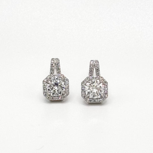 Square cushion diamond stud earrings with halo surround, sparkling in silver tone