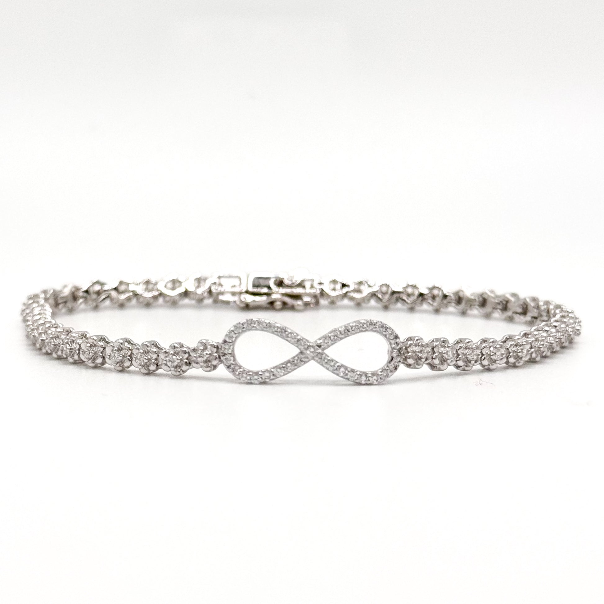 Silver infinity bracelet with crystal tennis links and an infinity symbol charm.