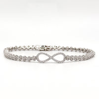 Silver infinity bracelet with crystal tennis links and an infinity symbol charm.