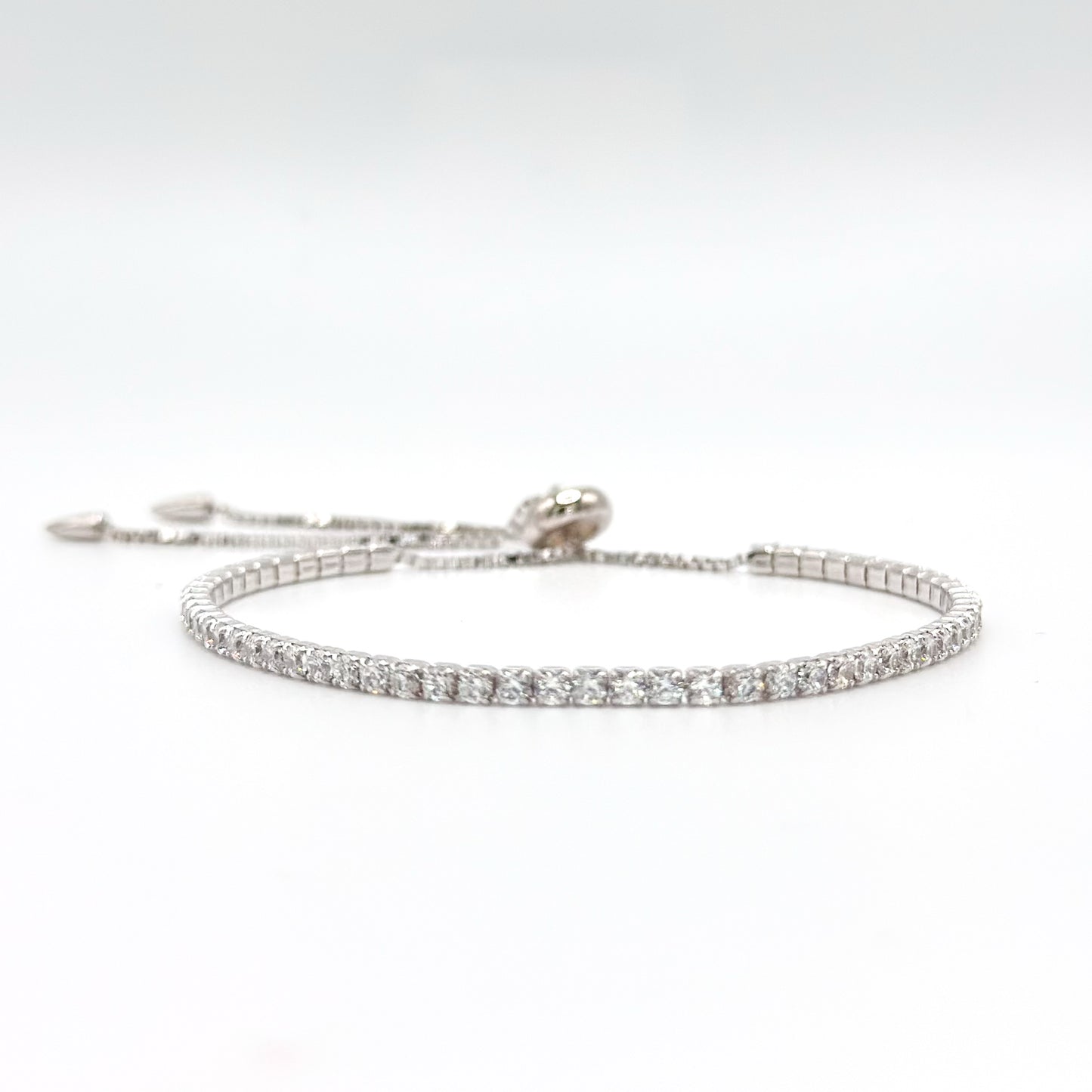 Adjustable tennis bracelet, silver-tone with round rhinestone row and hook clasp