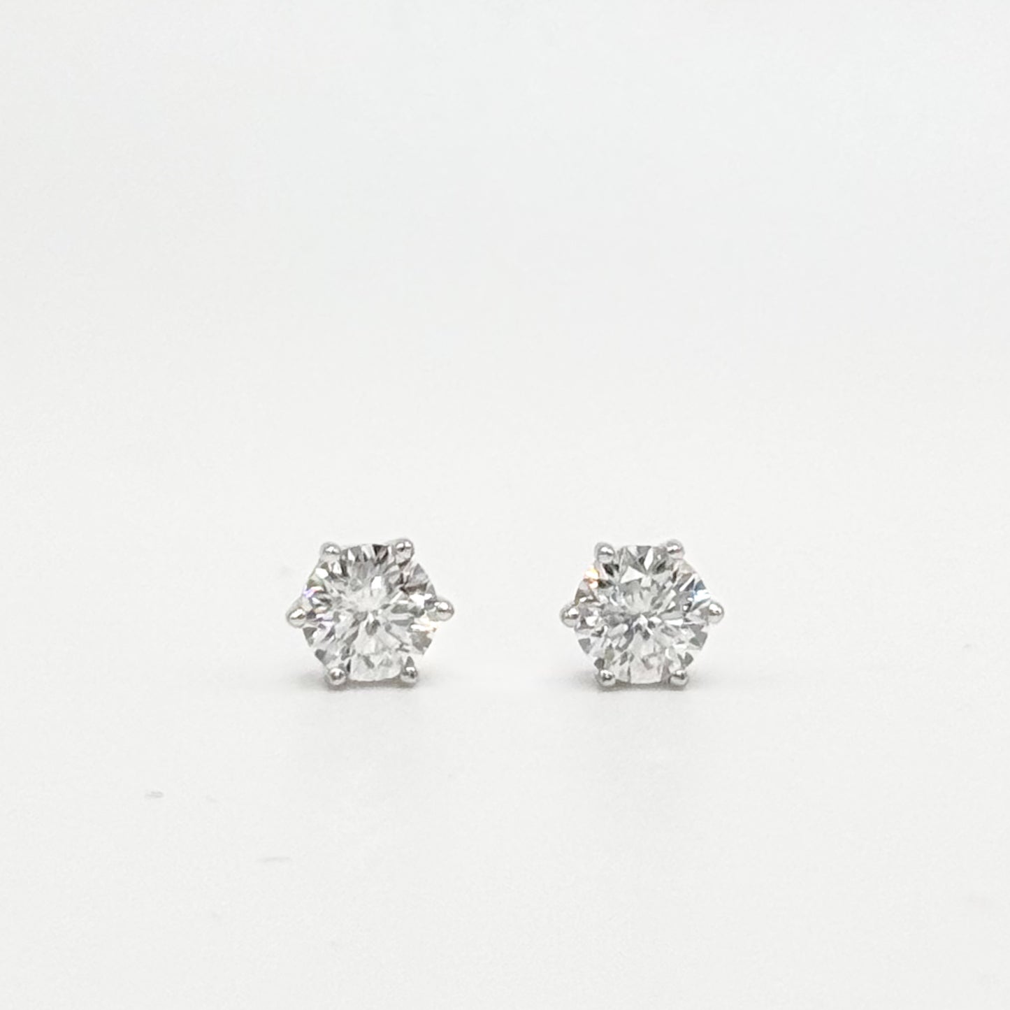 Round lab-grown diamond stud earrings with prong settings, silver-toned posts