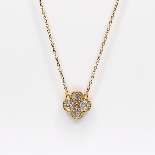Gold four-leaf clover pendant necklace with glittery charm on chain