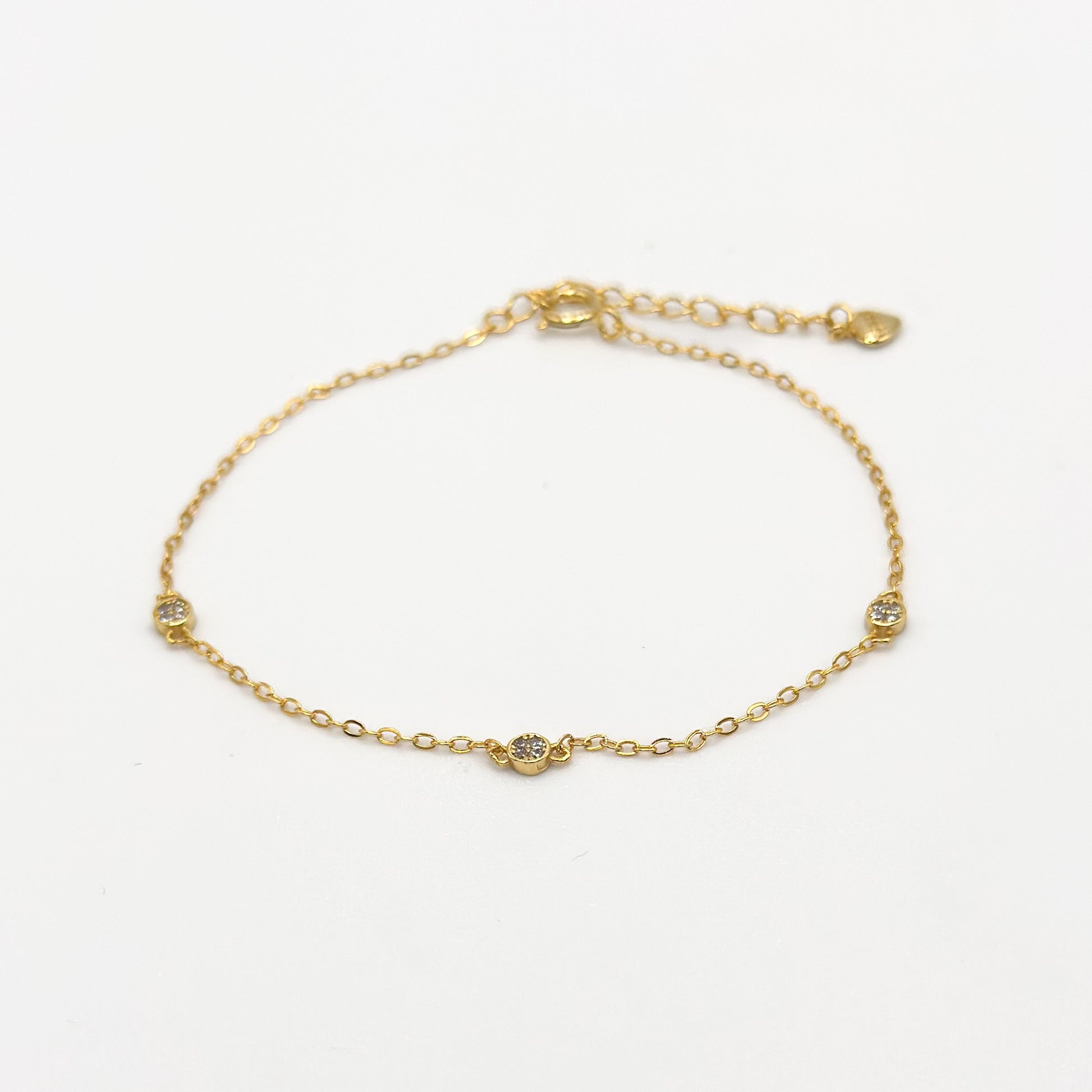 Gold CZ diamond trio bracelet with three small round stones on a delicate chain