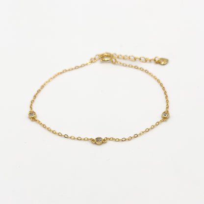 Gold CZ diamond trio bracelet with three small round stones on a delicate chain