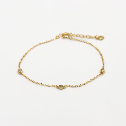 Gold CZ diamond trio bracelet with three small round stones on a delicate chain