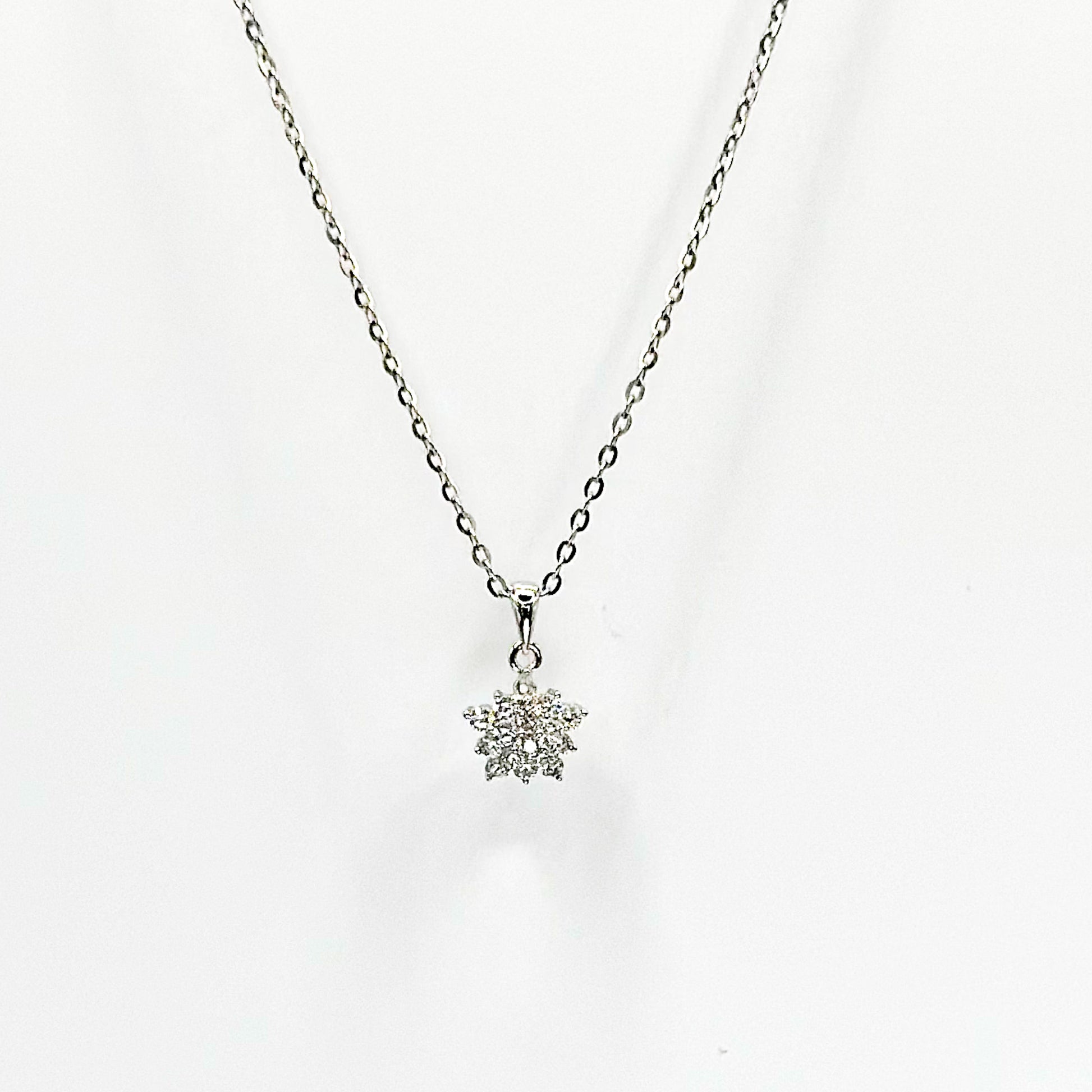 Dainty silver-tone necklace with snowflake charm pendant on link chain