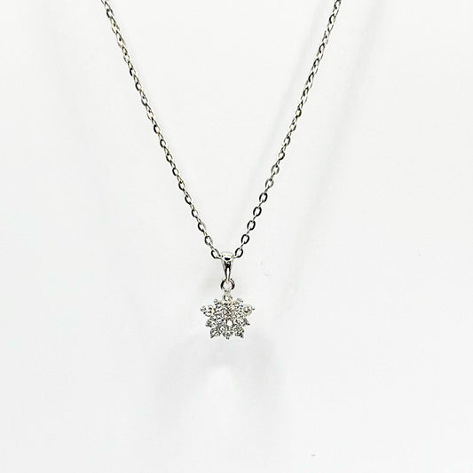 Dainty silver necklace with delicate chain and small snowflake-style pendant