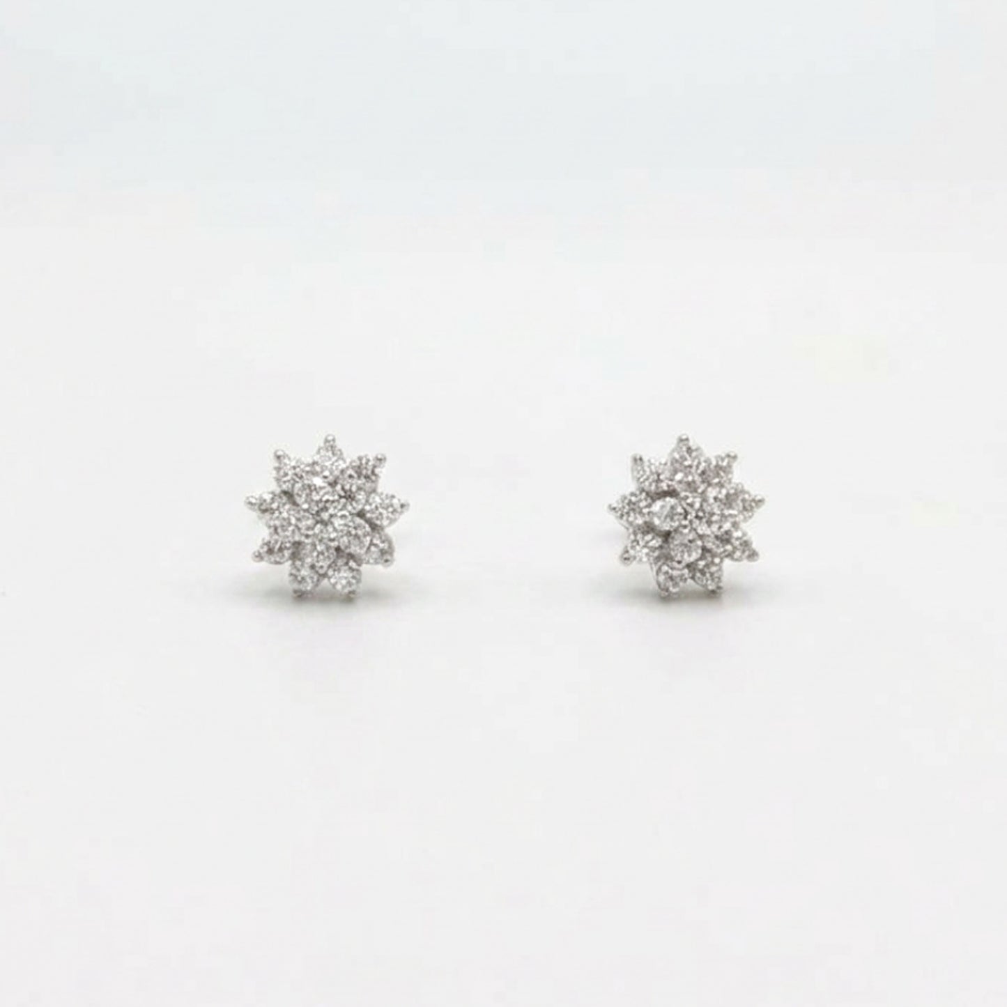 Sterling silver starburst stud earrings, front view pair