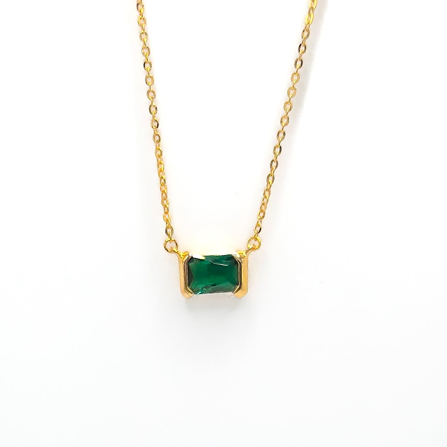 Gold pendant necklace with square emerald-green gemstone