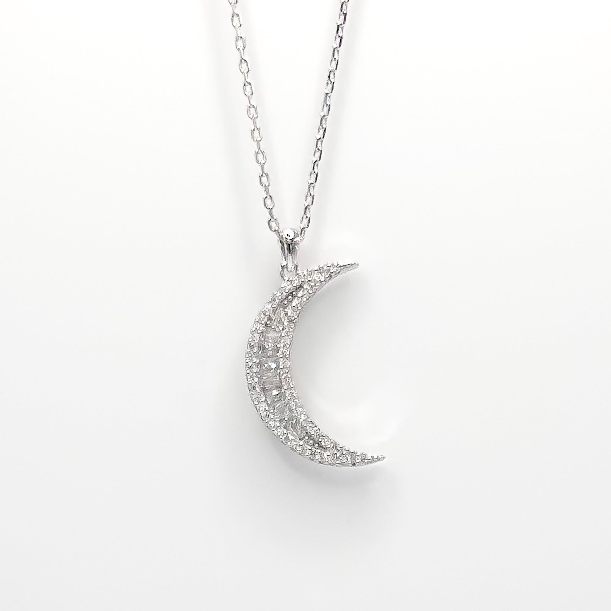 Silver crescent moon pendant necklace with sparkling pave details and chain