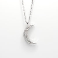 Silver crescent moon pendant necklace with sparkling pave details and chain