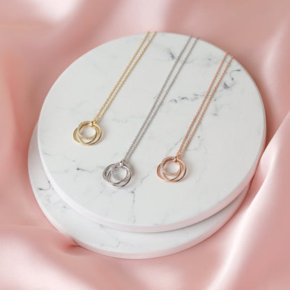 Gold, silver, and rose gold rings necklace pendants on chains
