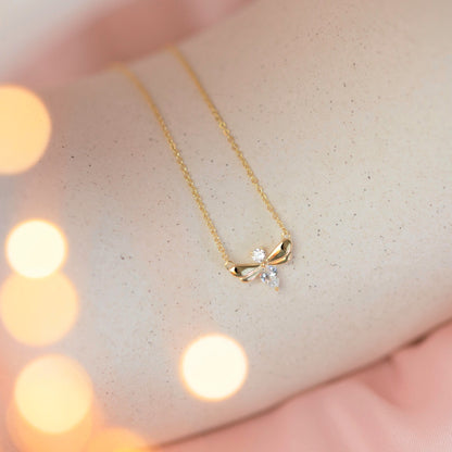 Firefly bracelet close-up with gold-tone chain and small flower charm