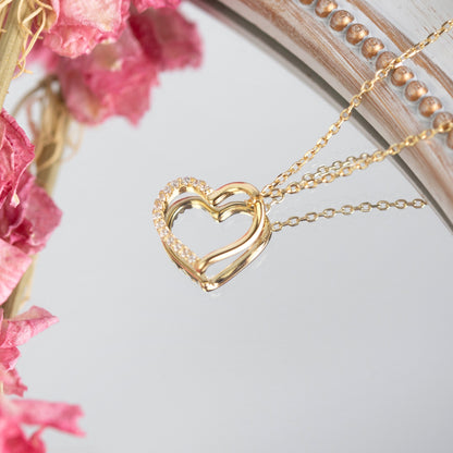Gold open heart pendant necklace with rhinestone detail and linked chain