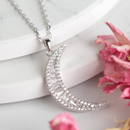 Crescent moon pendant necklace with pavé stones on a silver chain