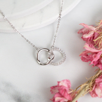 Silver mother-daughter necklace with double ring pendant and rhinestone accents