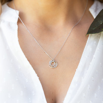 Silver rings necklace on thin chain with small round interlocking pendant