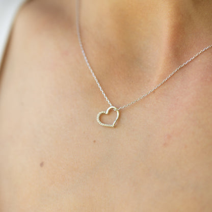 Silver open heart pendant necklace with sparkling center on a fine chain