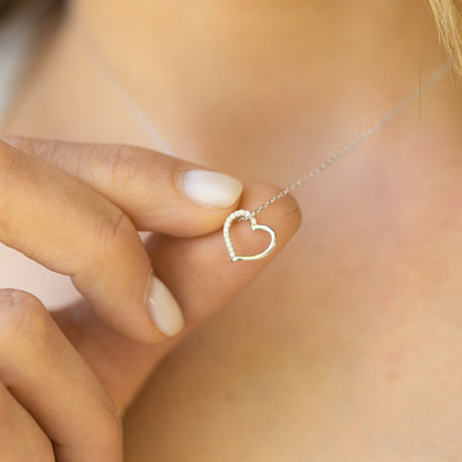 Silver open heart pendant necklace with small clear stone outline and chain