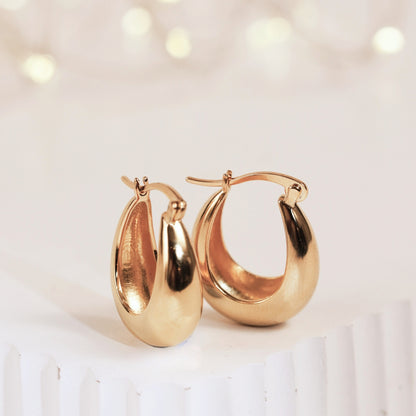 Gold chunky hoop earrings with thick oval hoops