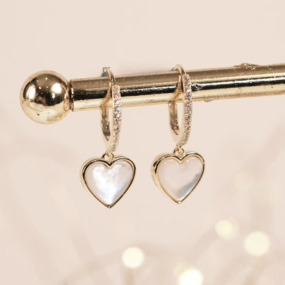 Gold heart drop earrings with white iridescent heart pendants and rhinestone hoops
