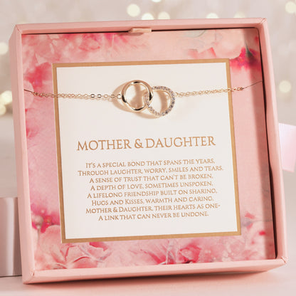 Bracelet with interlocking rings in a decorative box with floral design and sentimental message for mother and daughter.