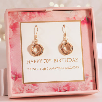 Gold-tone dangling hoop earrings with stacked ring charm