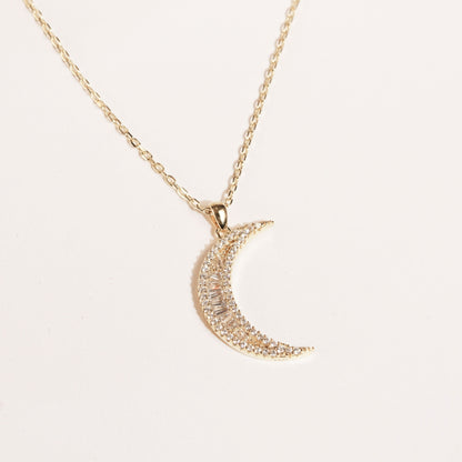 Crescent moon pendant necklace with pavé stones on a gold chain