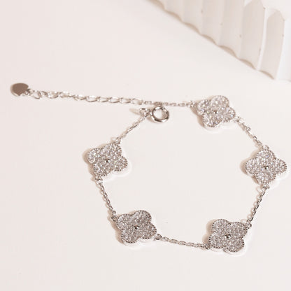 Sterling silver clover bracelet with five sparkling clover charms and a lobster clasp.