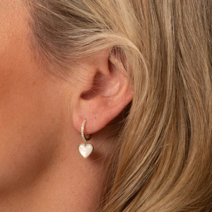 Gold heart drop earrings with white heart pendant on small hoop