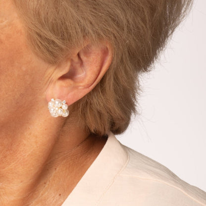Pearl cluster stud earrings with round white pearls and small sparkle accents