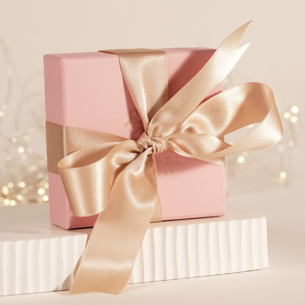 Pink gift box with satin gold bow ribbon