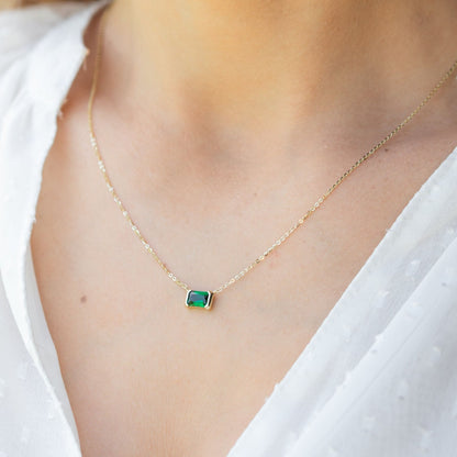Gold emerald pendant necklace with green square gemstone on fine chain