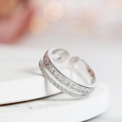 Sterling silver adjustable ring with double row of clear pave stones, angled view