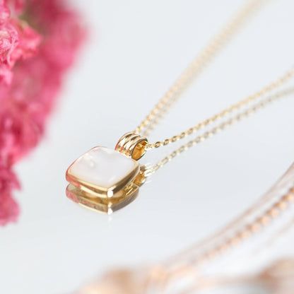 Pendant necklace with square mother-of-pearl charm in open gold setting