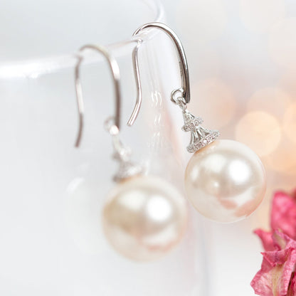 Silver pearl hook earrings, large round pearls with sparkling crystal caps, side view
