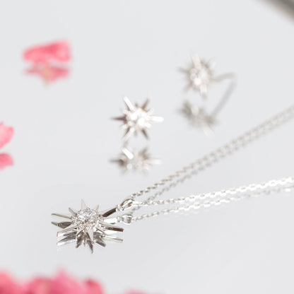 Silver starburst crystal stud earrings with round clear center stones