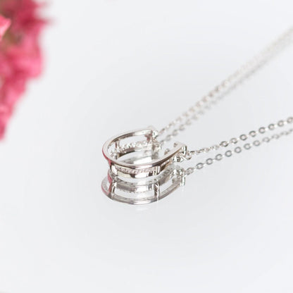 Silver horseshoe pendant necklace with stacked U design and pavé sparkle