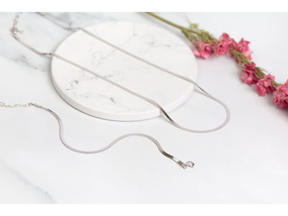 Silver flat snake chain bracelet with small clasp and dangling end