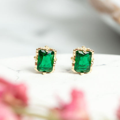 Gold emerald stud earrings with square green gemstones, bezel settings, post backs