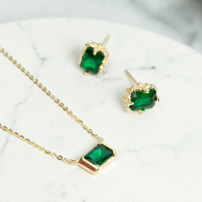 Gold emerald stud earrings with square green gemstones, gold filigree bezels
