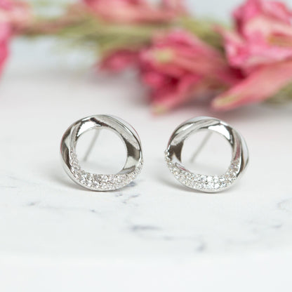 Pair of sterling silver circle stud earrings, textured ring with clear stones